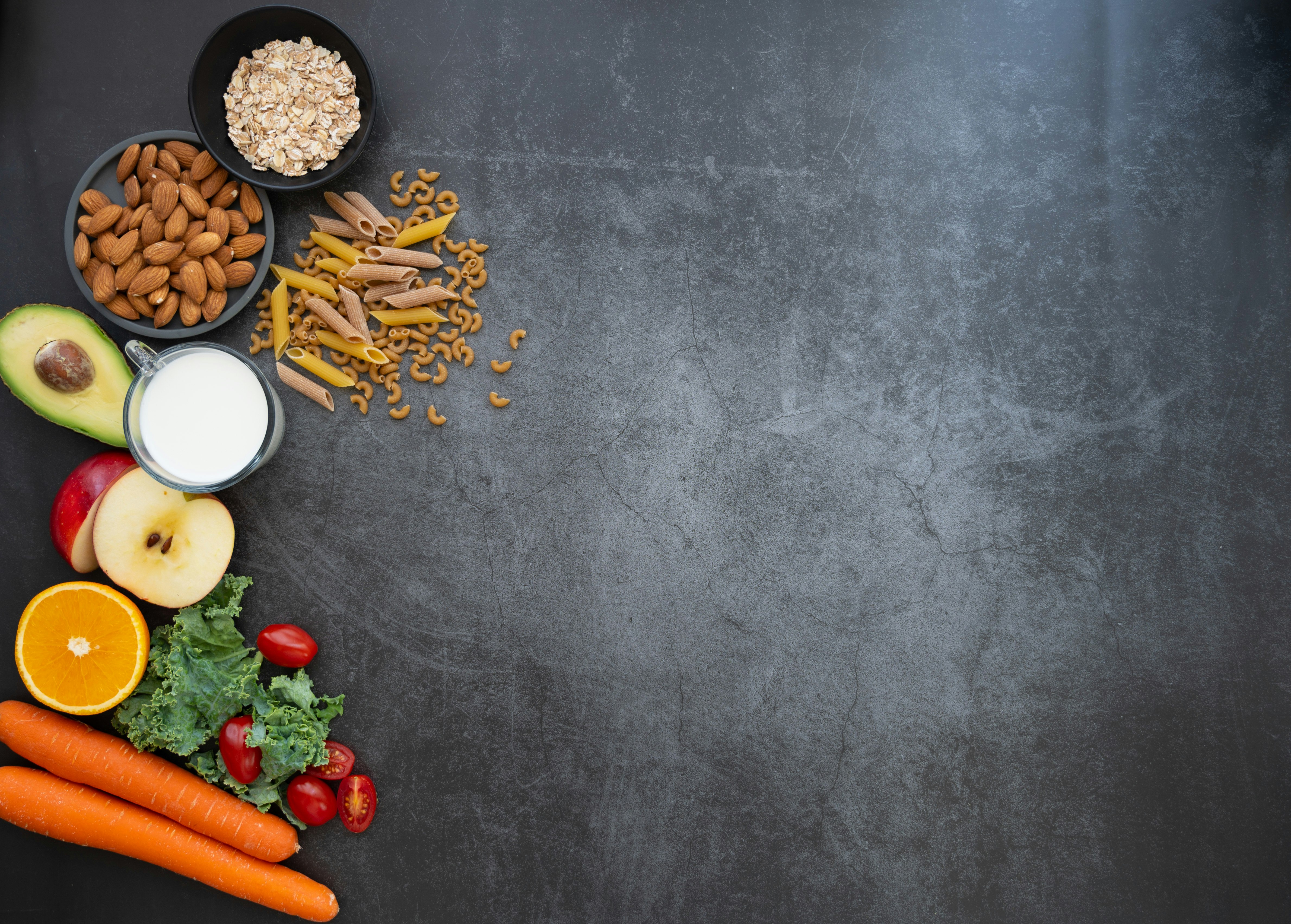 A black table topped with fruits and vegetables
